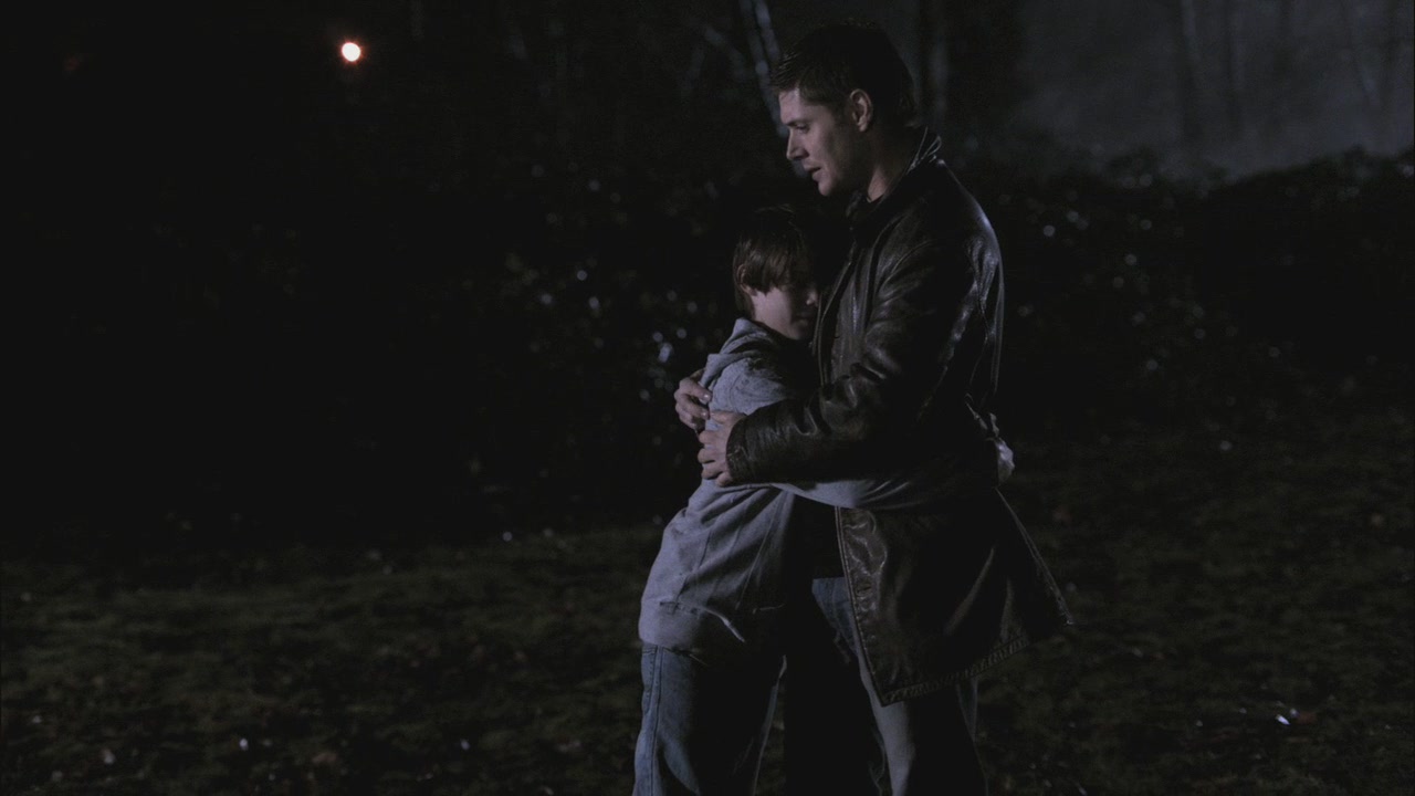 Distance shot of young Sam hugging adult Dean